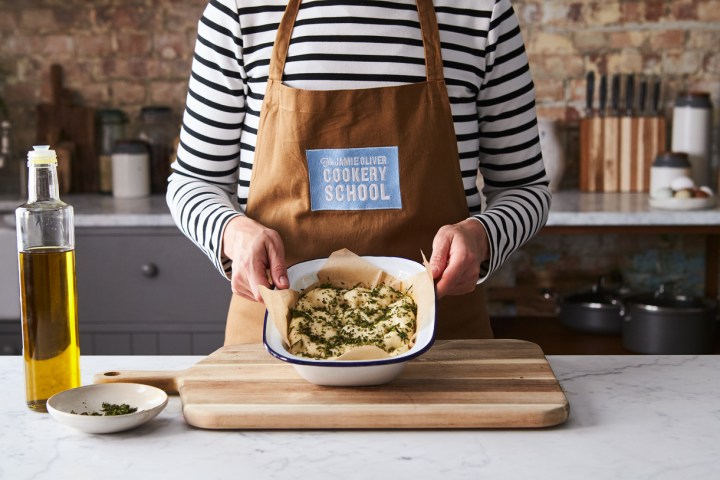 a woman sitting at a table with a plate of food