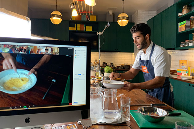 a man sitting at a desk in front of a computer