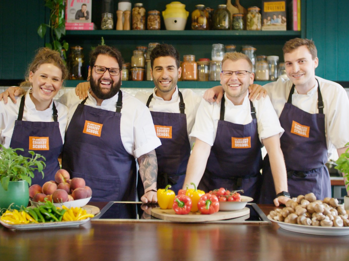 a group of people sitting at a table full of food