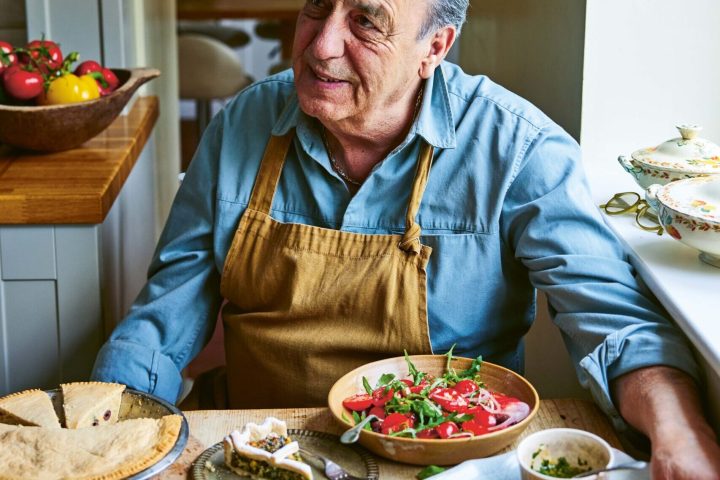 a man sitting at a table with a plate of food