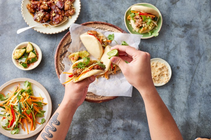 a group of people sitting at a table with a plate of food