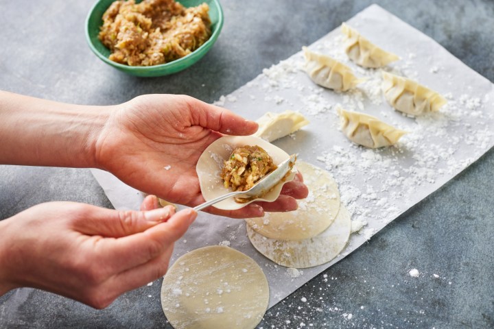 a person holding a piece of food