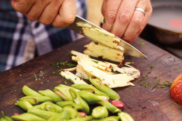 a person with a knife on a cutting board
