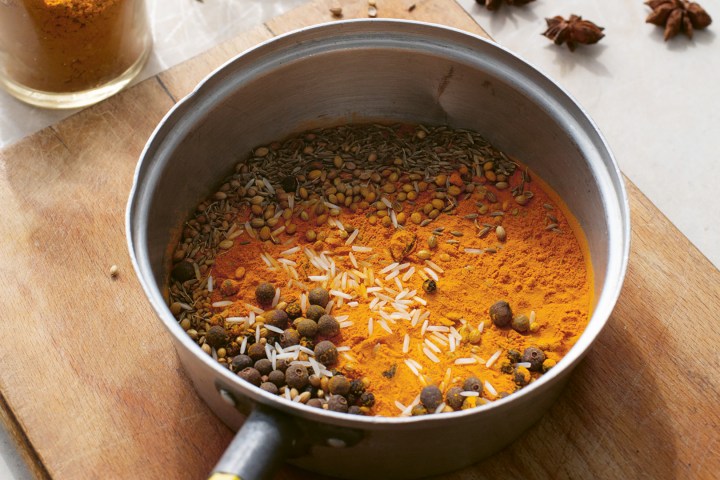 a bowl of soup sitting on top of a wooden table